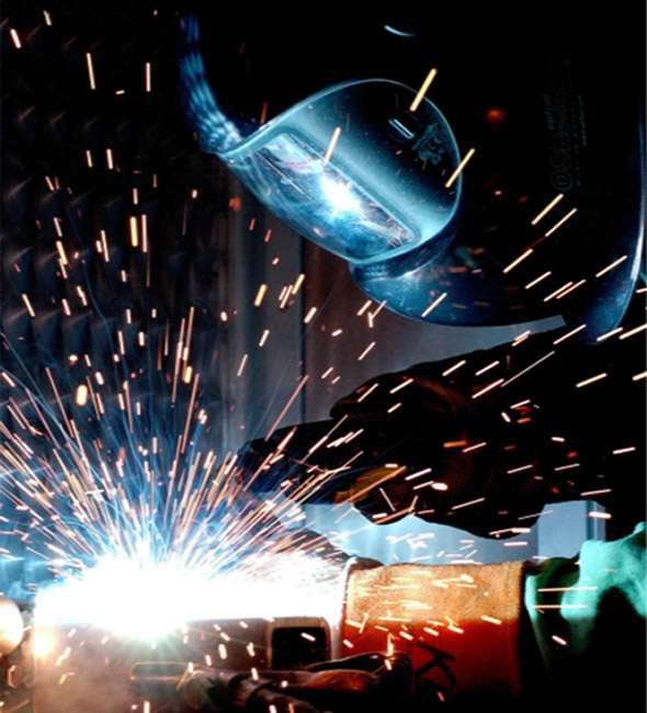 Metal welder at work with mask